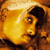 Pixelated static image of a person's face with warm orange and yellow tones, featuring dark hair and visible facial features against a gradient background.
