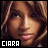 Pixelated close-up of a person's face with brown hair and light skin tone, featuring visible facial features including eyes, nose, mouth, and eyebrows, with text "CIARA" in white block letters at the bottom left on black background.