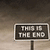 identical road sign icons displaying 'THIS IS THE END' text against a cloudy sky background