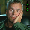 A person in a green jacket rests their head on one hand, with vertical text appearing to the right of them