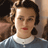 A pixelated contact sheet showing two frames of a 48x48 animated buddy icon featuring a woman with curly brown hair and red lipstick on the left frame, next to the word "OCELLIA" in blocky text on the right frame against a light background.