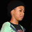 Pixelated image of a person with dark hair wearing a light-colored shirt with dark accents, green text reading "Diggy S." and a green heart symbol on a black background.