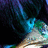 Pixelated abstract composition with dark blue and black background, vertical cyan streaks, green and white lower section.