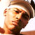 Pixelated static image of a person's face with brown hair and light skin tone, cropped to show only the upper portion including eyes, nose, mouth, and part of the forehead.