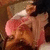 A person with dark hair and a pink headband lies down, eyes closed in three showing slight facial movement