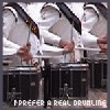 showing a person in white uniform playing drums with drumsticks, text below reads "I PREFER A REAL DRUHLING"