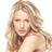 Pixelated image of a person with long wavy light brown hair, fair skin, and visible shoulder. The background is solid white.