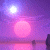 Pixelated scene with purple sky, bright white sun, pink circular object, and dark silhouettes on water reflection.