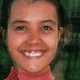 six pixelated faces with varying expressions and cropping, set against a green background with a red-collared garment visible on some faces