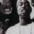 Two pixelated figures in black and white, one with a dark head and the other with a light head, positioned side-by-side against a light background.