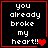 Black background with white pixelated text reading "you already broke my heart!!" and red heart symbols in a