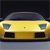 Static pixelated image of a yellow car's front view with dark headlights and grille, set against a dark background.