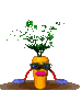 Animated carrot character with green leafy top, dark blue sunglasses, pink lips, and alternating blue/red arms standing on brown soil patch against gray background.