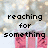 Pixelated text reads 'reaching for something' over pink gift boxes with white ribbons against a blurred background of lights.