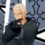 A pixelated image shows a person with short light hair in dark clothing against a blue patterned background, next to white text reading "the gambler of fate" on black.
