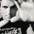 Static grayscale icon of a person's face with visible pixelation and dithering effects, cropped to show upper facial features against a light background.