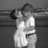 Black-and-white pixelated image of two people embracing, with red text overlays on a black background.