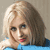 Static pixelated image of a person with light brown hair wearing a blue top against a neutral background.