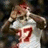 Pixelated image of a person in white sports jersey with red number 17, arms raised against dark background.