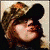 A pixelated animated icon shows a person with light brown hair wearing a camouflage cap, transitioning from side profile to front view.
