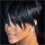 Pixelated close-up of a person's face with dark hair, light skin, and a neutral expression against a dark background.