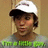 Pixelated image of a person wearing a white cap with a dark brim, brown hair, and a green and gray striped shirt against a beige background.