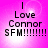 A pink background with four identical text blocks reading "I Love Connor SFM!!!!!!!!" in black pixelated font, each block containing a bright white light effect.