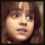 Three pixelated close-up portraits of a person with brown hair in a , each showing different facial expressions and slight head angles