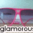 Pixelated image of a pink hourglass with blue and purple background, partially obscured text reading 'glamorous' at bottom.