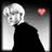Pixelated grayscale icon of a person with short light hair and dark clothing, featuring a small colored square in the top-right corner.