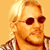 A 2x2 contact sheet of a pixelated animated icon featuring a blonde man with sunglasses and a checkered shirt, alongside text reading "CoolBuddy.com" on a blue background in one frame.