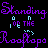 Purple and cyan pixelated text repeats 'Standing' and 'Roofops' on a black background with partial phrases like 'WAIT UNTIL THE BOMB DROPS'.