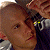 A 50x50 pixel animated buddy icon featuring a split composition with a person on the left and green text on the right, displayed as two sequential frames in a contact sheet layout.
