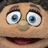Six distinct puppet faces and an orange Q symbol arranged in a , with one empty