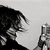 Black-and-white animated icon shows a person with dark hair holding a microphone against light background, head turning left to right.