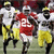 Two identical pixelated football scenes with players in red and yellow uniforms, side-by-side on a white background.