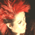 Red-haired figure with side profile and downward gaze in upper half, mirrored inverted pose below against dark background.
