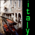 A vertical strip of pixelated text 'italy' appears on a black background, with the left side showing two identical images of an ancient stone relief featuring human figures and architectural elements.