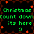 Green pixelated text reads "Christmas Count down its here" with a smiley face on black background, surrounded by red star-like shapes.