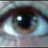 A pixelated close-up of a human eye on the left, with blue background text reading 'Real Eyes', 'Realize', and 'Lies' in light cyan.