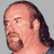 Pixelated static image of a man's head and shoulders with long dark hair, beard, and mustache against gray background.