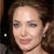 Pixelated close-up of a person with brown hair, light skin, and a neutral expression, wearing a small earring.