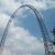 Pixelated static image showing a curved dark gray structure against light blue and white background with no visible text or distinct subjects.