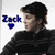 Pixelated image of a person with dark hair in black clothing, next to blue text reading "Zack" and a heart symbol on white background, with green side showing partial text