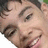 Pixelated close-up of two smiling faces with dark hair, one face partially overlapping the other against a light background.