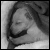 A four- shows a grayscale anime-style character sleeping under blankets, with pixelated text changing