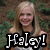 Pixelated image of a smiling person with long light brown hair wearing a sleeveless top, overlaid with large white text reading "Haley!" on black background.