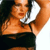 A pixelated figure with light brown skin holds a silver microphone close to their mouth, wearing a black sleeveless top against a dark background.