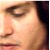 Pixelated close-up of a person's face showing eye, nose, and mouth with warm skin tones and dark hair on the right side.