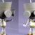 Two identical pixelated figures with gray helmets, black faces, and white-and-gold bodies stand against a purple background.